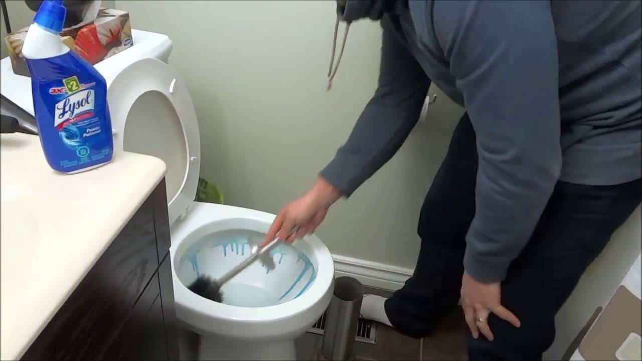 scrubbing toilet bowl